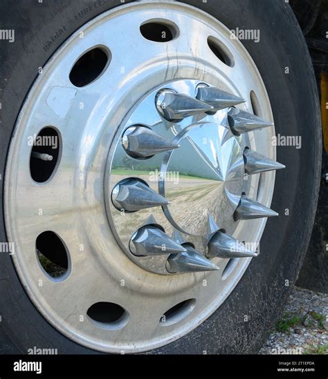 Truck Tire Sporting A Shiny Wheel With Chrome Spiked Lug Nuts Stock