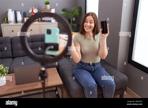 Beautiful Brunette Woman Recording Vlog Tutorial With Smartphone At Home Celebrating Achievement