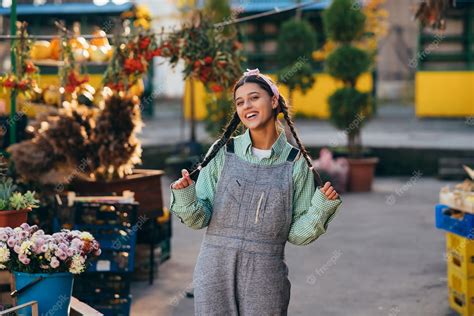 Premium Photo | Playful farmer woman in denim overalls smiling sincerely while posing