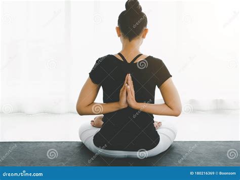 Asian Women Doing Yoga Meditating Exercise At Home Sitting In Lotus