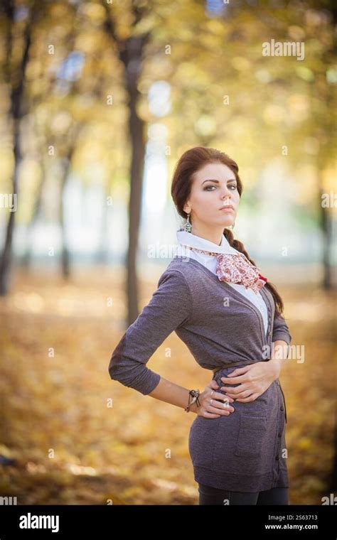 Captured Amidst The Mesmerizing Beauty Of The Autumn Forest A Graceful Brunette Girl Radiates
