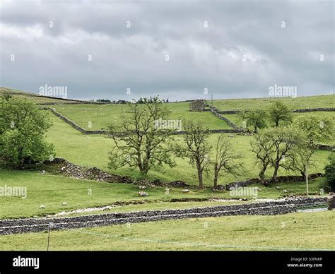 Scenic Rural Landscape With Dramatic Grey Sky In Malham Yorkshire