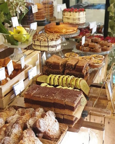 Many Different Types Of Desserts On Display At A Bakery