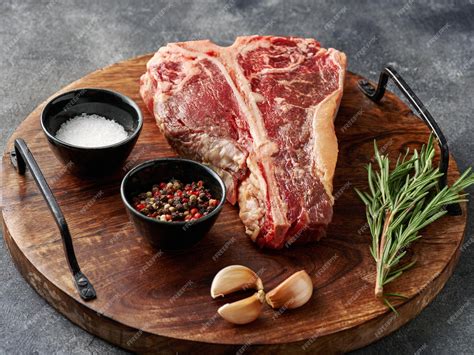 Premium Photo Tbone Or Porterhouse Raw Steak Of Beef Cut From The