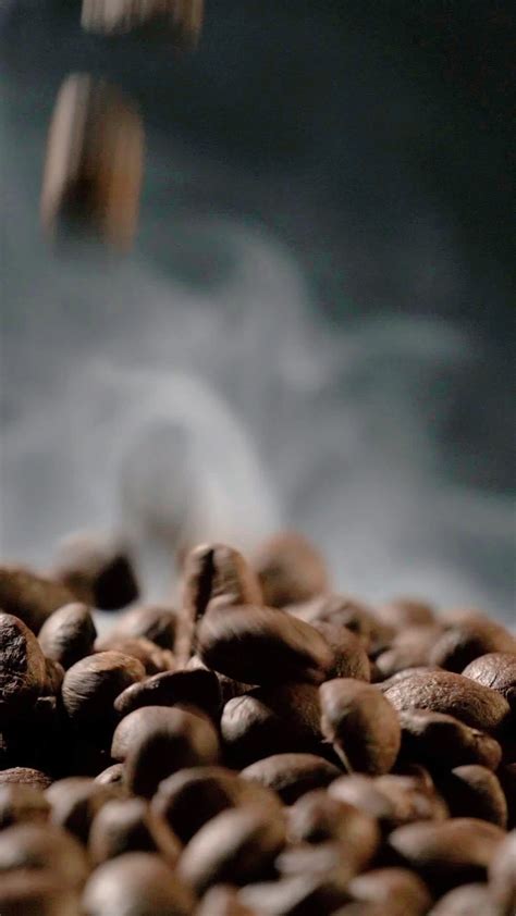 Vertical Slow Motion Of Roasted Coffee Beans Falling Organic Coffee