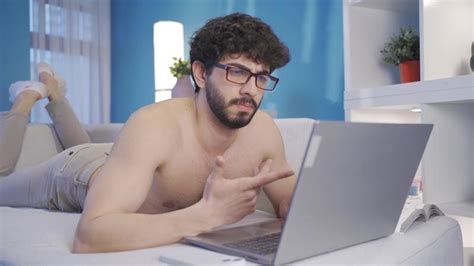 Successful And Smart Man Using Laptop Naked At Home Working Naked