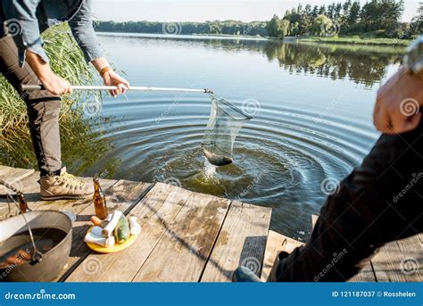 Fisherman catching fish stock image. Image of blue, summer - 121187037