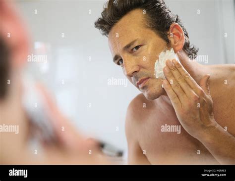Mature Handsome Man Shaving In Front Of Mirror Stock Photo Alamy