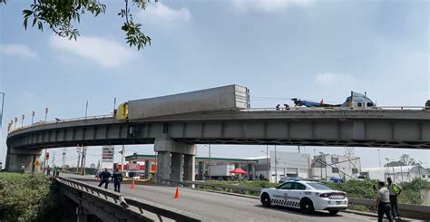 VIDEO Tráiler vuelca y queda colgado en puente del Circuito Exterior