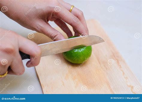 Hands Slicing A Lime With A Chef Knife Stock Image Image Of Board