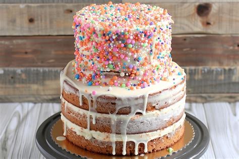 Premium Photo A Naked Carrot Cake With Minimal Frosting Between Layers