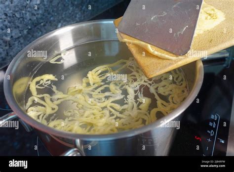 Swabian Cuisine Preparation Of Hand Scraped Spaetzle For Spaetzle