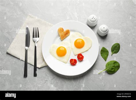 Heart Shaped Fried Eggs With Toast Served On Marble Table Flat Lay