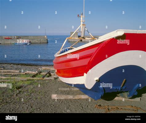 Traditional Wooden Coble Fishing Boat And The Harbour Craster