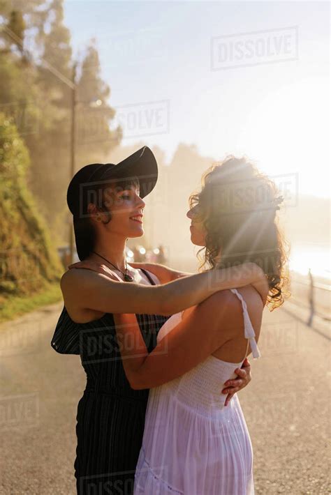 Delighted Lesbian Couple Cuddling During Sundown Royalty Free Stock Photo Dissolve