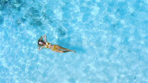 Beautiful Woman In Bikini Relaxing And Swim In Blue Sea Aerial Top