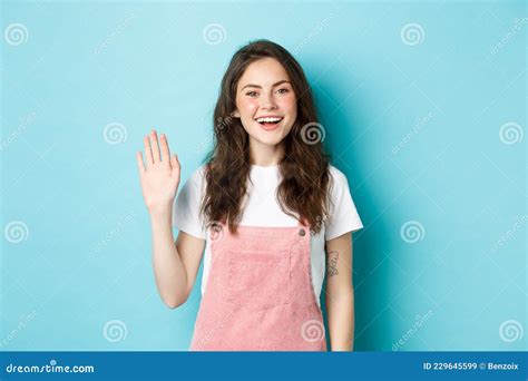 Hello Nice To Meet You. Beautiful Friendly Girl Waving Hand To Say Hi ...