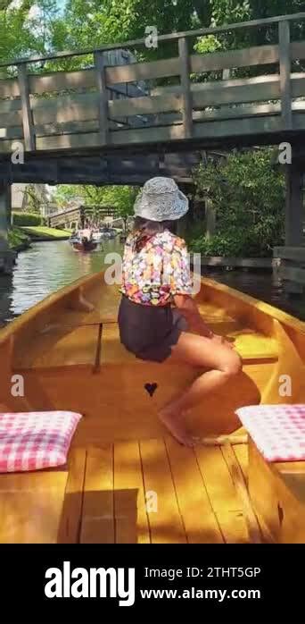 Giethoorn Canals Holland An Asian Woman With Hat In A Wooden Boat At