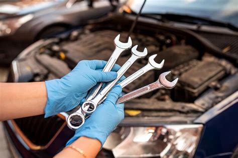 Premium Photo Car Mechanic Repairman Hands Repairing Car Engine Of