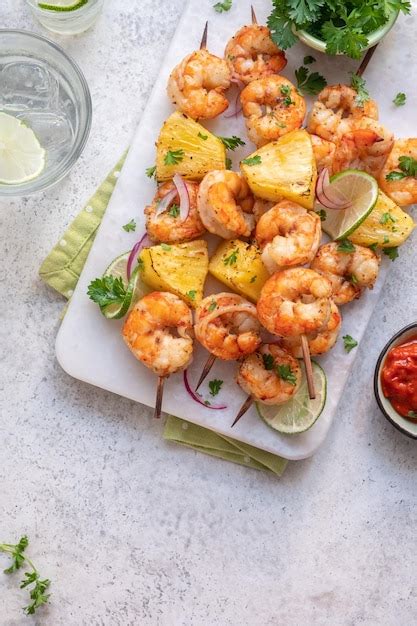 Premium Photo Skewers Of Barbecued Shrimp With A Pineapple