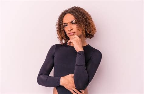 Joven Mujer Transexual Latina Aislada De Fondo Rosa Pensando Y Mirando Hacia Arriba Siendo