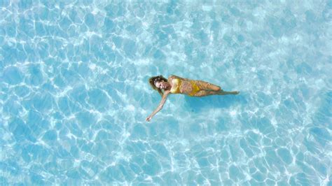 Woman Chilling In Water In Tropical Blue Sea Aerial Top Down View With