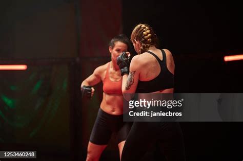 Female Mma Fighters Throw Punches In Octagon High-Res Stock Photo ...