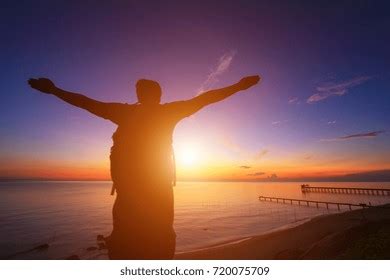 Silhouette Man Hands Raised Beautiful Sunrise Stock Photo