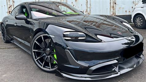 A Black Sports Car Parked In Front Of A Building