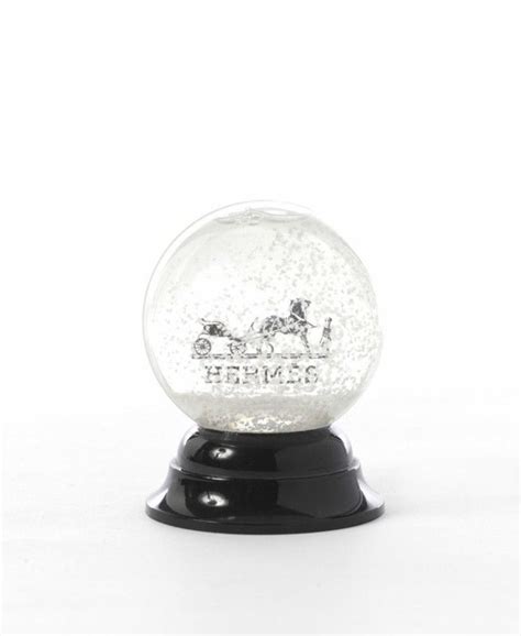 Two Snow Globes Sitting On Top Of Each Other