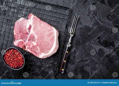 Uncooked Raw Pork T Bone Chop Meat Steak On Grill Black Background