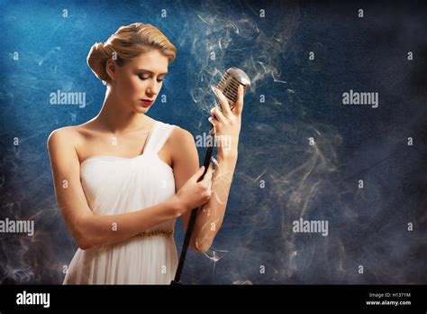 Beautiful Blonde Woman Singer With A Microphone Stock Photo Alamy