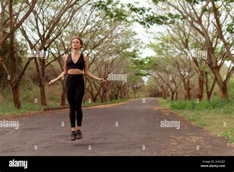 Woman Jumping Rope In Black Sportwear Bali Stock Photo Alamy