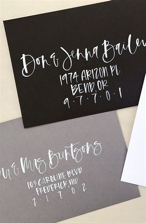 Three Black And White Envelopes With Calligraphy On Them