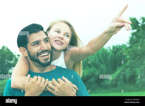 Portrait Of Smiling Couple Who Are Viewing Nature In The Park Stock