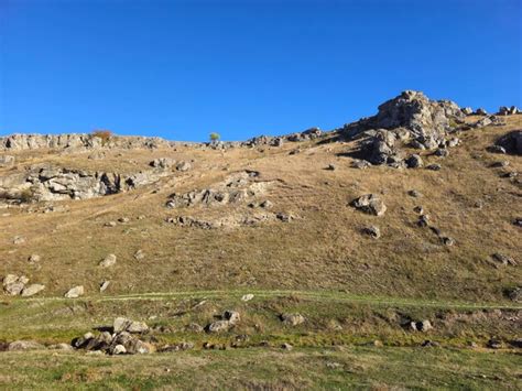 Premium Photo A Rocky Hill With A Blue Sky