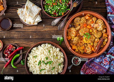 Traditional Tajine Dishes Couscous And Fresh Salad On Rustic Wooden