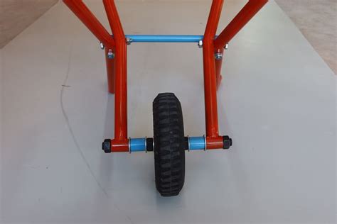 An Orange And Blue Tricycle With Two Wheels On The Front Wheel Is