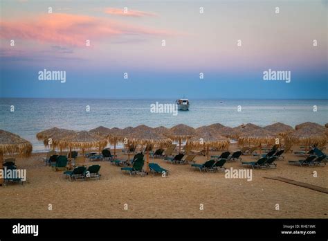 Beach Umbrella At Sunset View Of Chairs And Umbrellas On The Beach