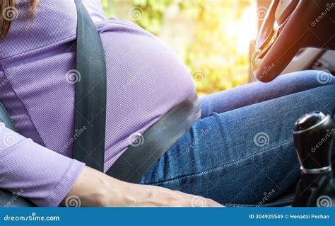 A Pregnant Woman Wearing A Seat Belt Drives A Car Safety And Driving