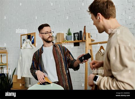 Two Men A Gay Couple Standing Side By Side In A Designer Workshop Working Together On Trendy