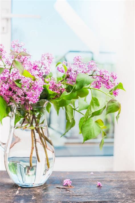 Lilac Flowers Bunch In Glass Vase On Window Still Photo Background And