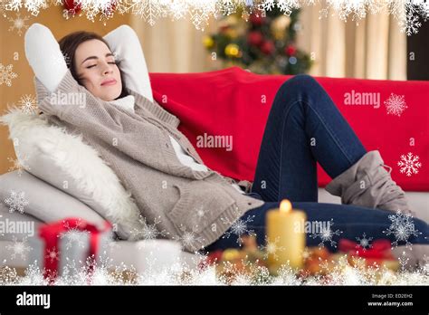 Composite Image Of Brunette Napping On The Couch At Christmas Stock Photo Alamy