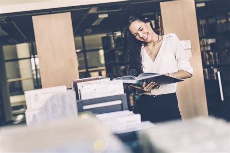 Beautiful Woman Reading Books In A Library Stock Image Image Of