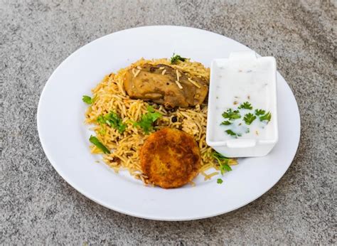 Premium Photo Chicken Biryani Or Pulao With Shami Kabab Tikki And