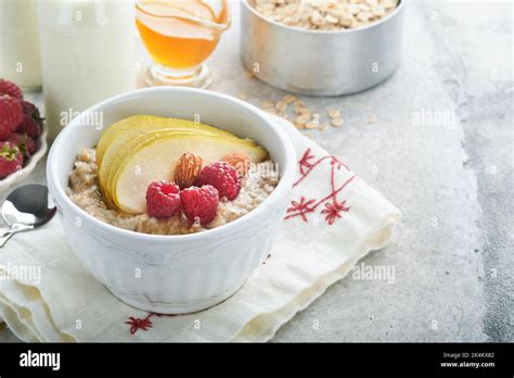 Oatmeal Bowl Of Oatmeal Porridge With Raspberry Pear And Honey On