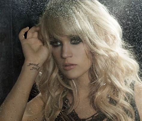A Woman With Long Blonde Hair Standing In Front Of A Mirror