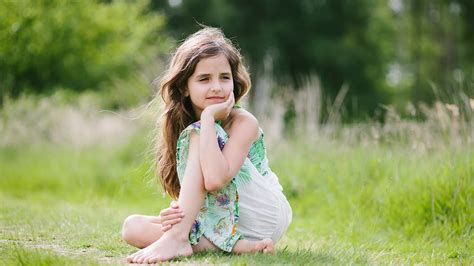 Black Long Hair Cute Little Girl Is Wearing Green White Dress Sitting