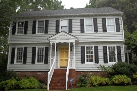 Grey House Black Shutters Yellow Door With Bricks Black Shutters