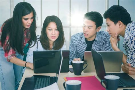 Premium Photo Freelance Team Using Laptops Near The Window